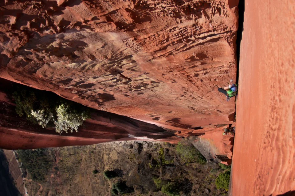 Liming crack climbing, sandstone cliff, two people and grass