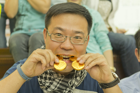 Man with chocolate gold coins on a management development program with Zen Quest Adventures