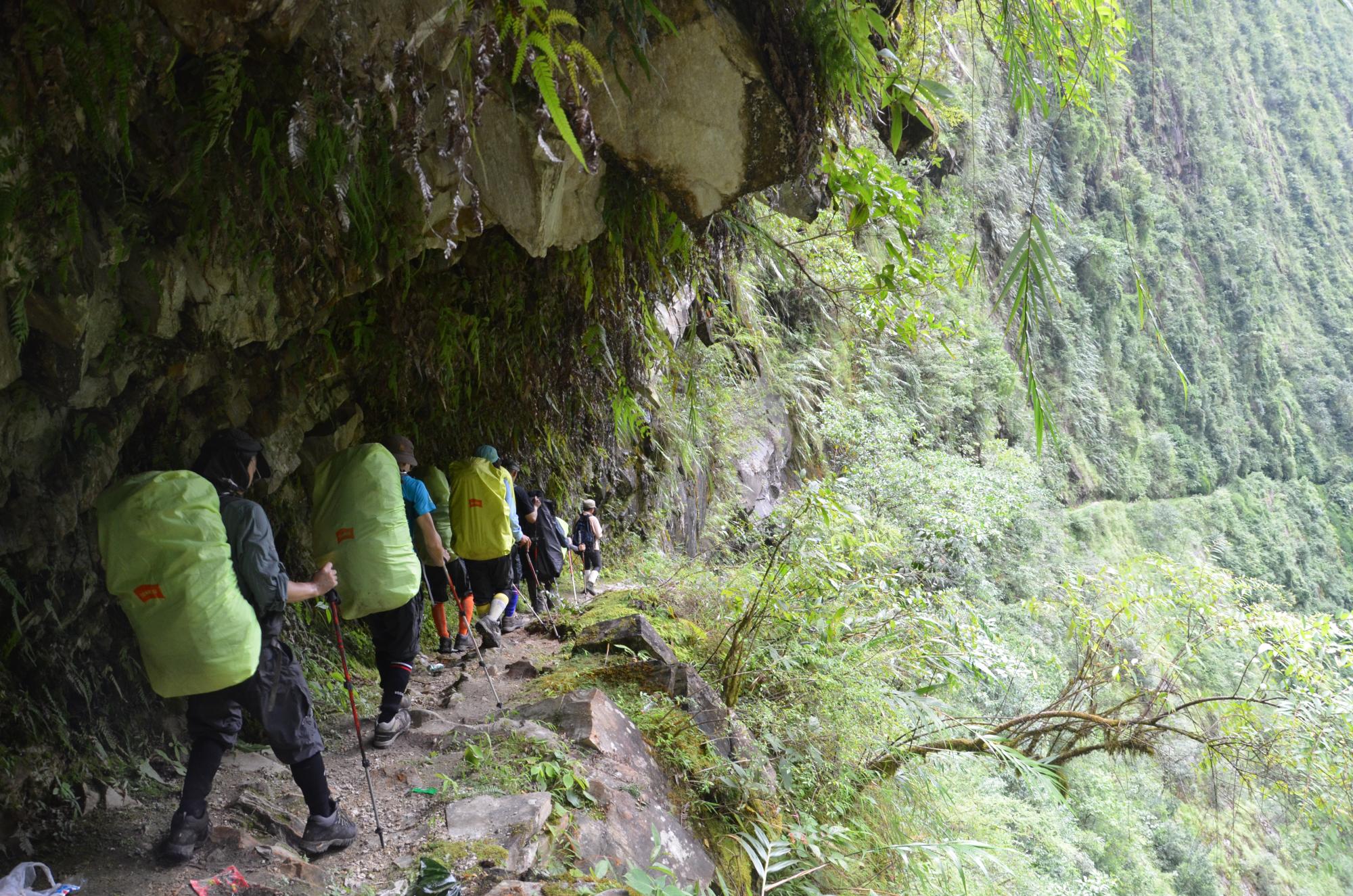 Trekking, Yunnan, China, yellow back packs covers on a narrow mountain path