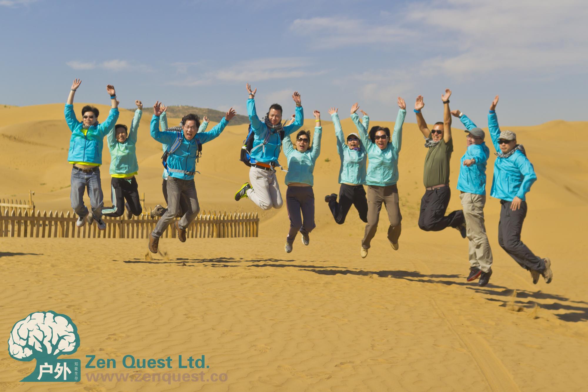 Jumping in the desert, old ZQ logo, Group of people, sand and sky
